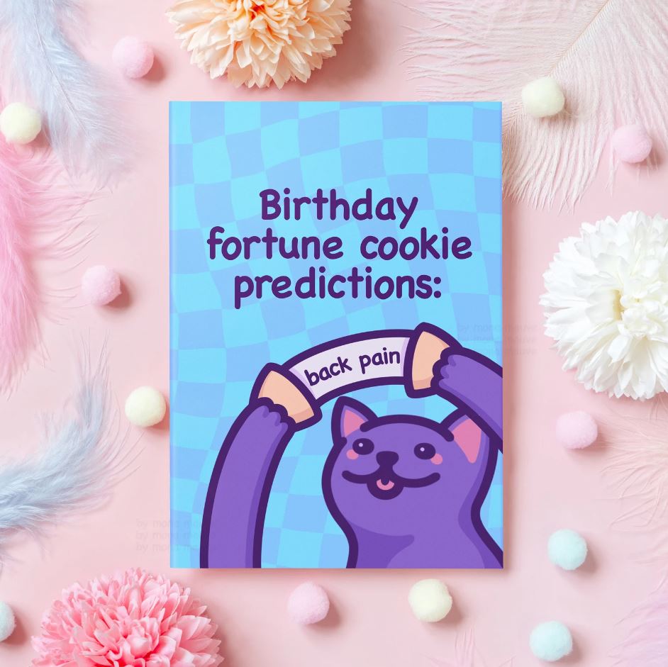 A greeting card with a cat holding a fortune cookie that reads 'back pain'