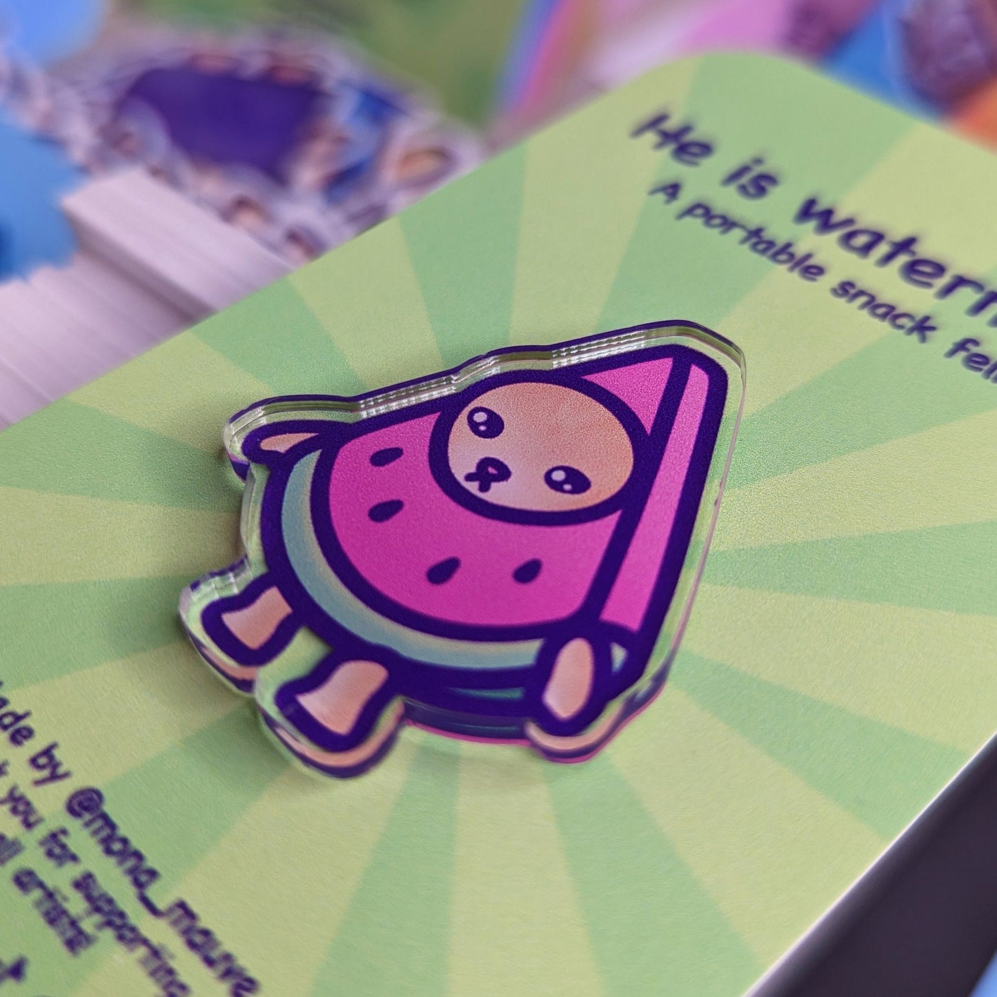 Close-up of the watermelon cat pin badge.